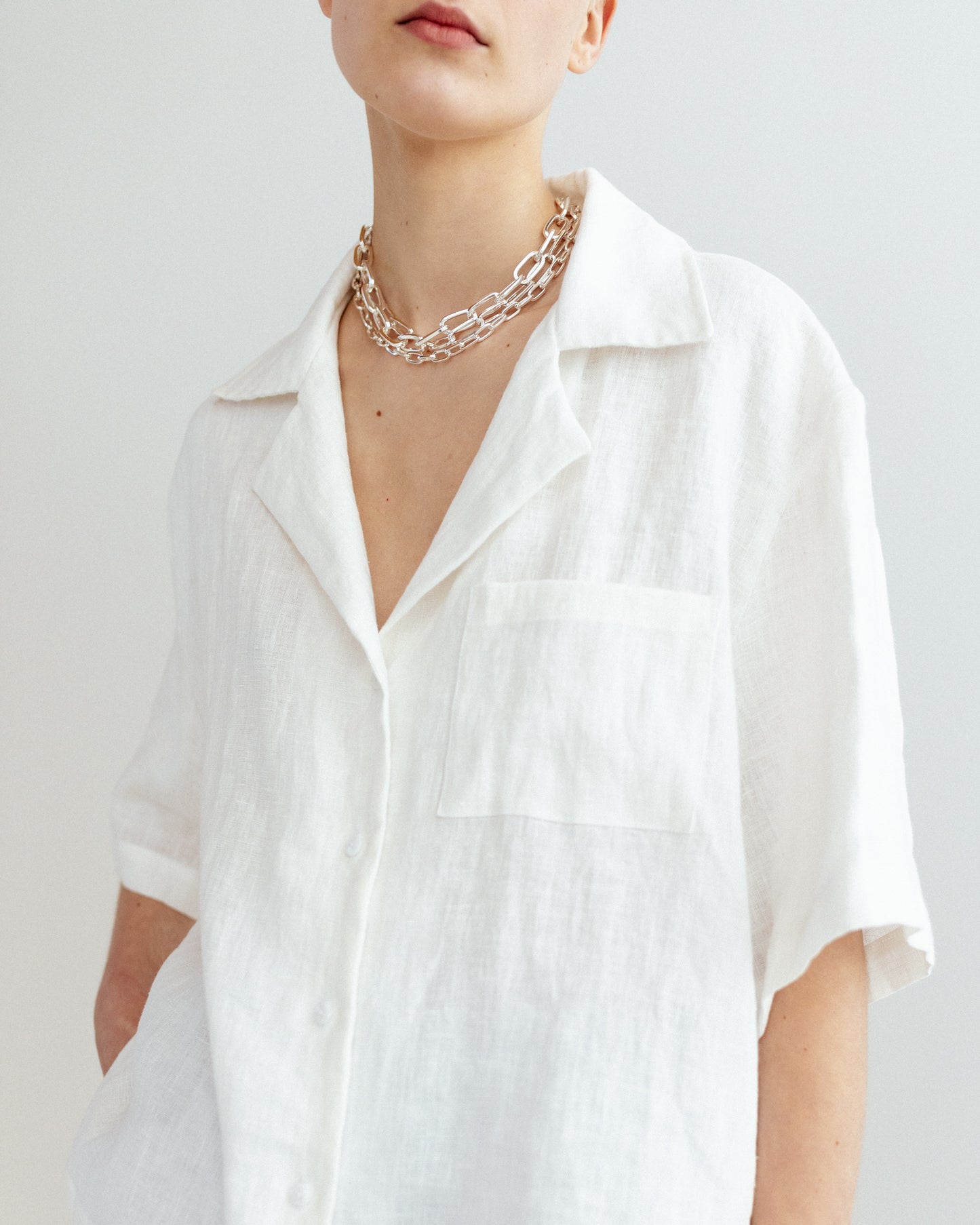 Open collar short sleeve shirt in white linen