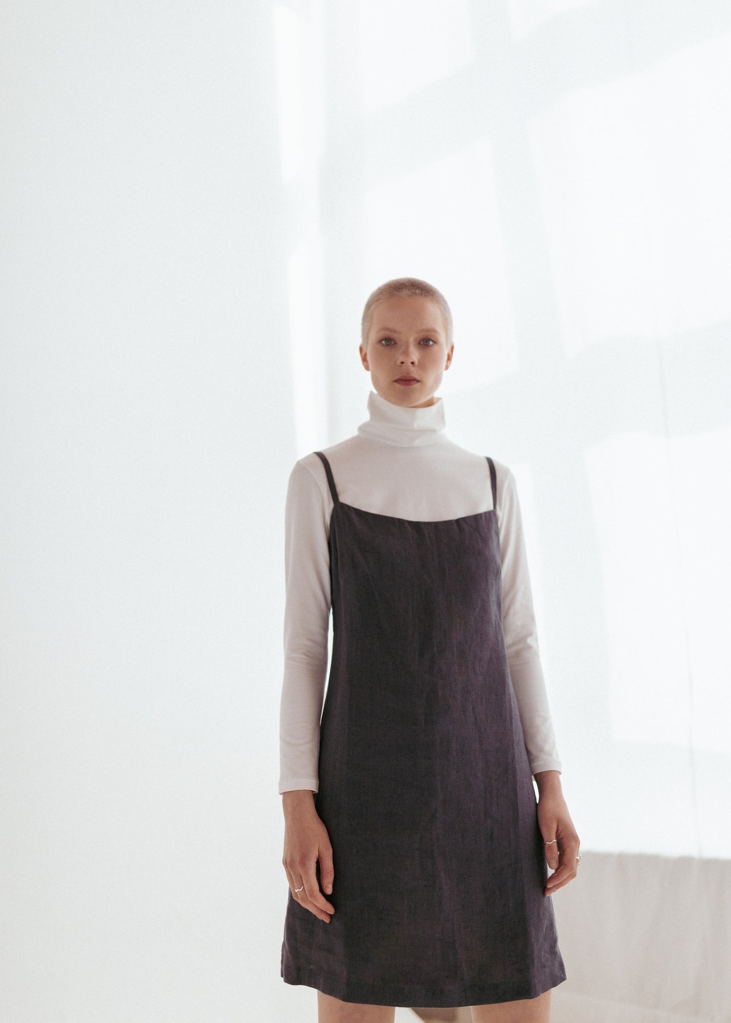 Dark grey linen strap dress and white organic roll neck
