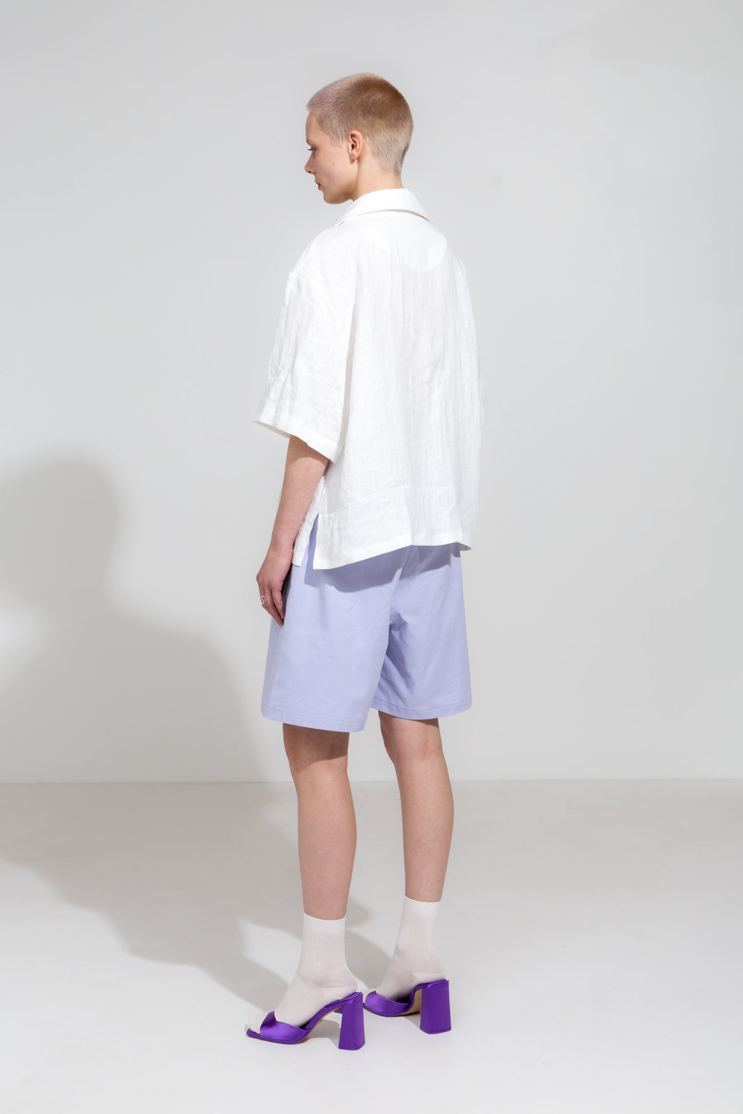 Open collar short sleeve shirt in white linen and lilac workwear shorts in organic cotton