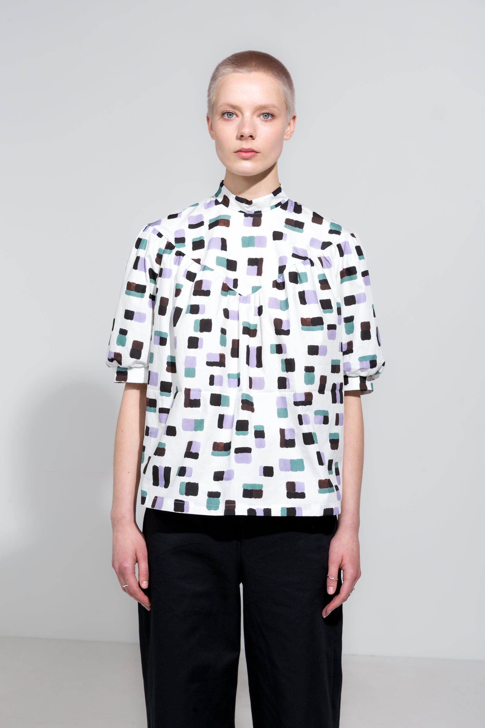 Puff sleeve shirt in print with high collar and black organic cotton workwear trousers