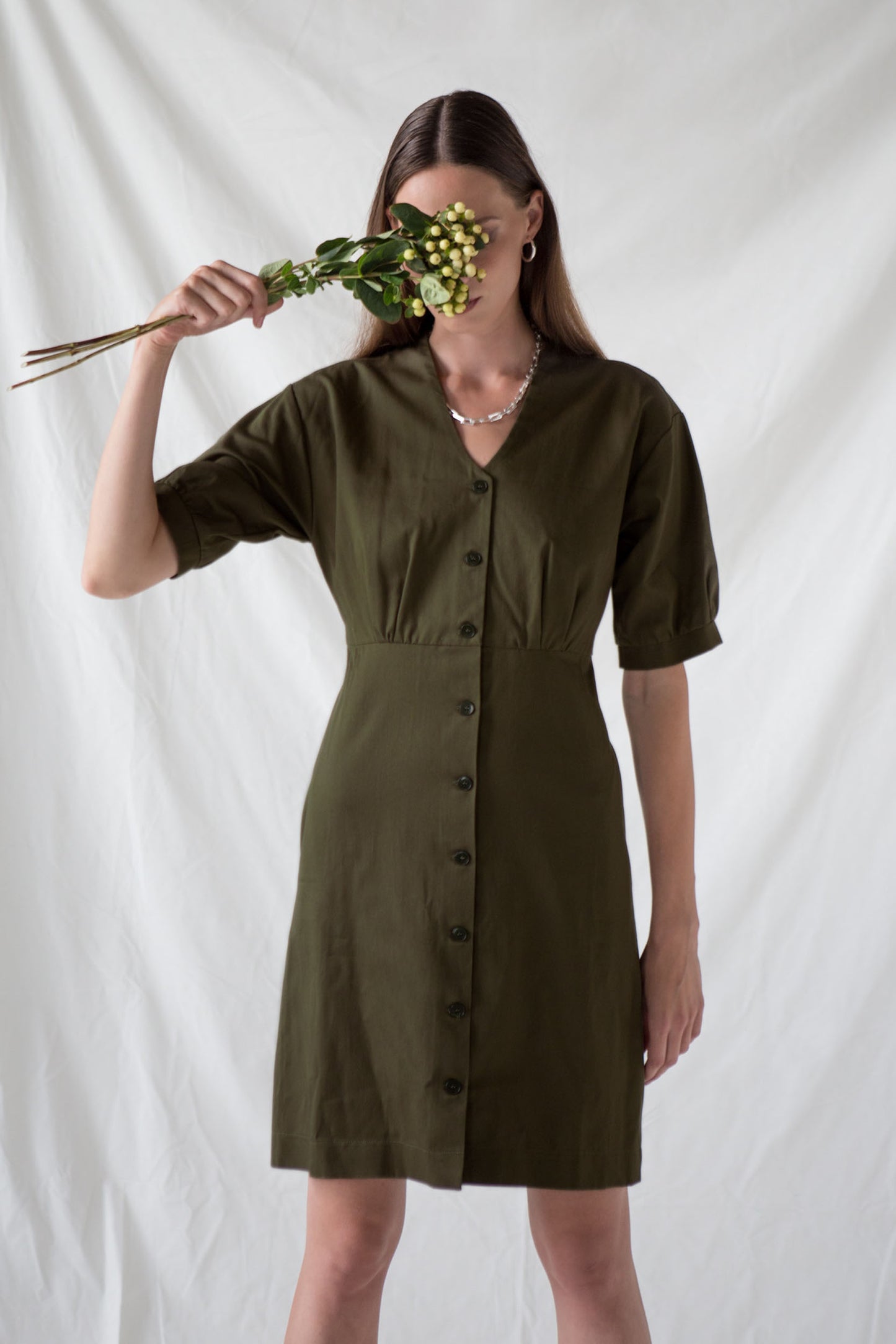 Dark green organic cotton dress with puff sleeves, knee length