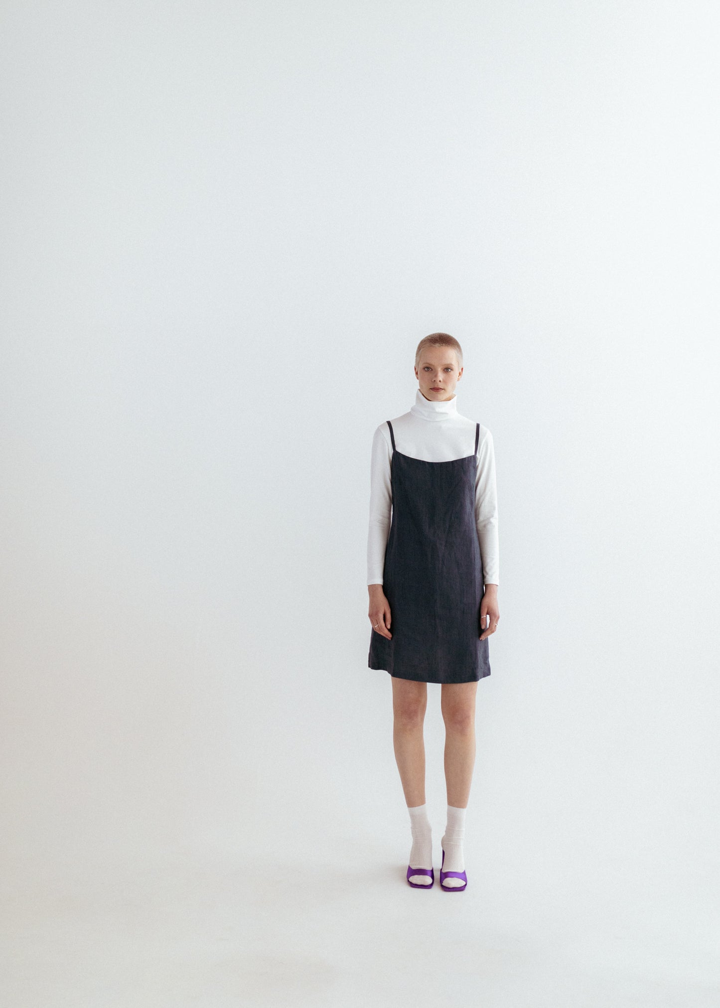 Dark grey linen strap dress and white organic roll neck