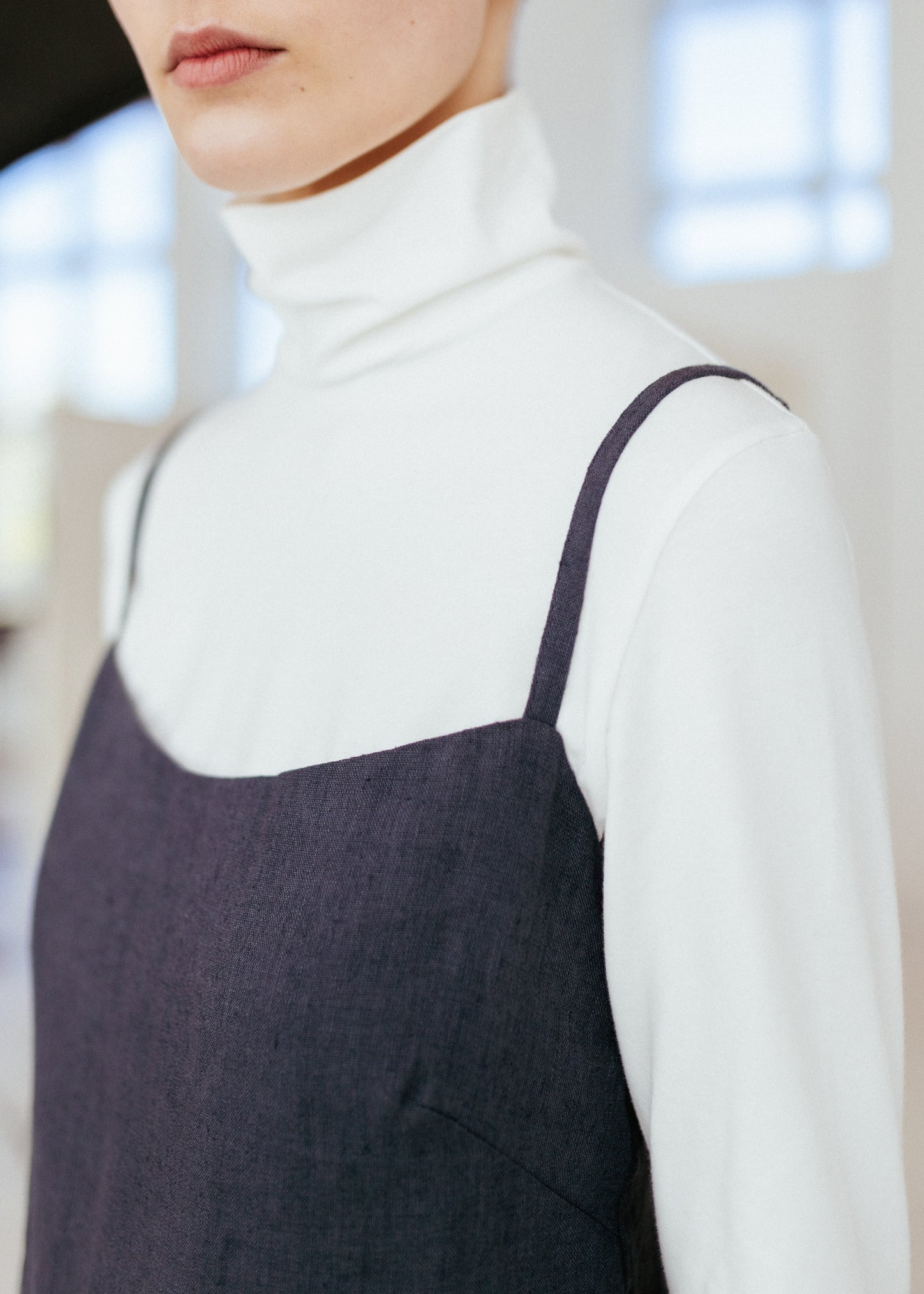 Dark grey linen strap dress and white organic roll neck