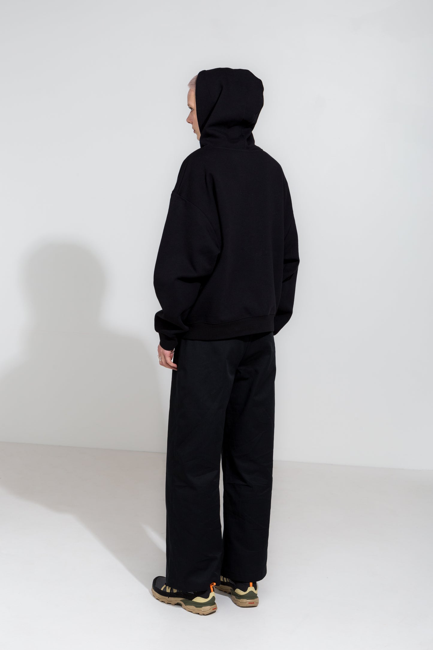 Black straight cut twill trousers and organic cotton hoodie jacket