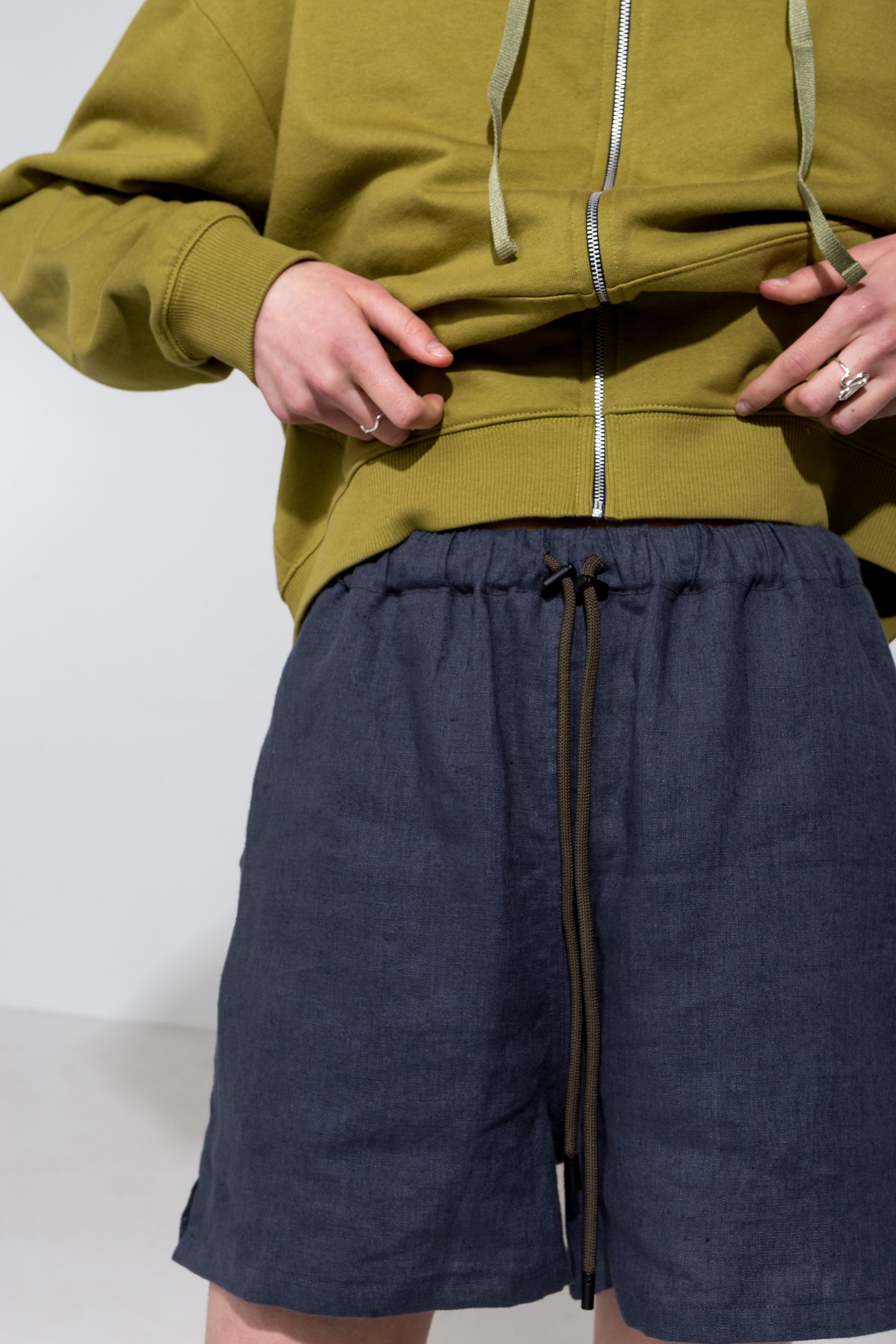 Relaxed fit linen shorts in dark grey and hoodie in olive green