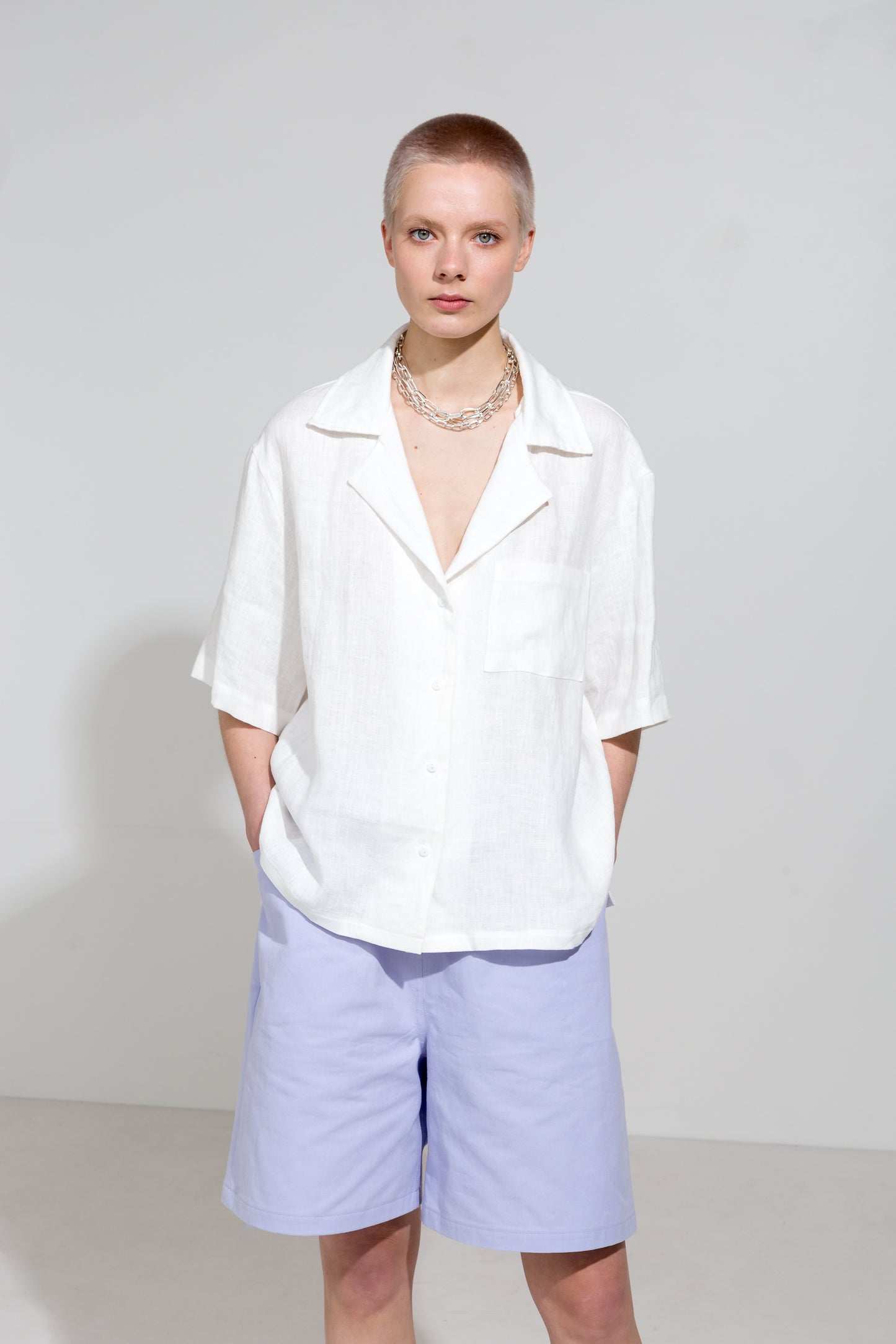 Open collar short sleeve shirt in white linen and lilac workwear shorts in organic cotton