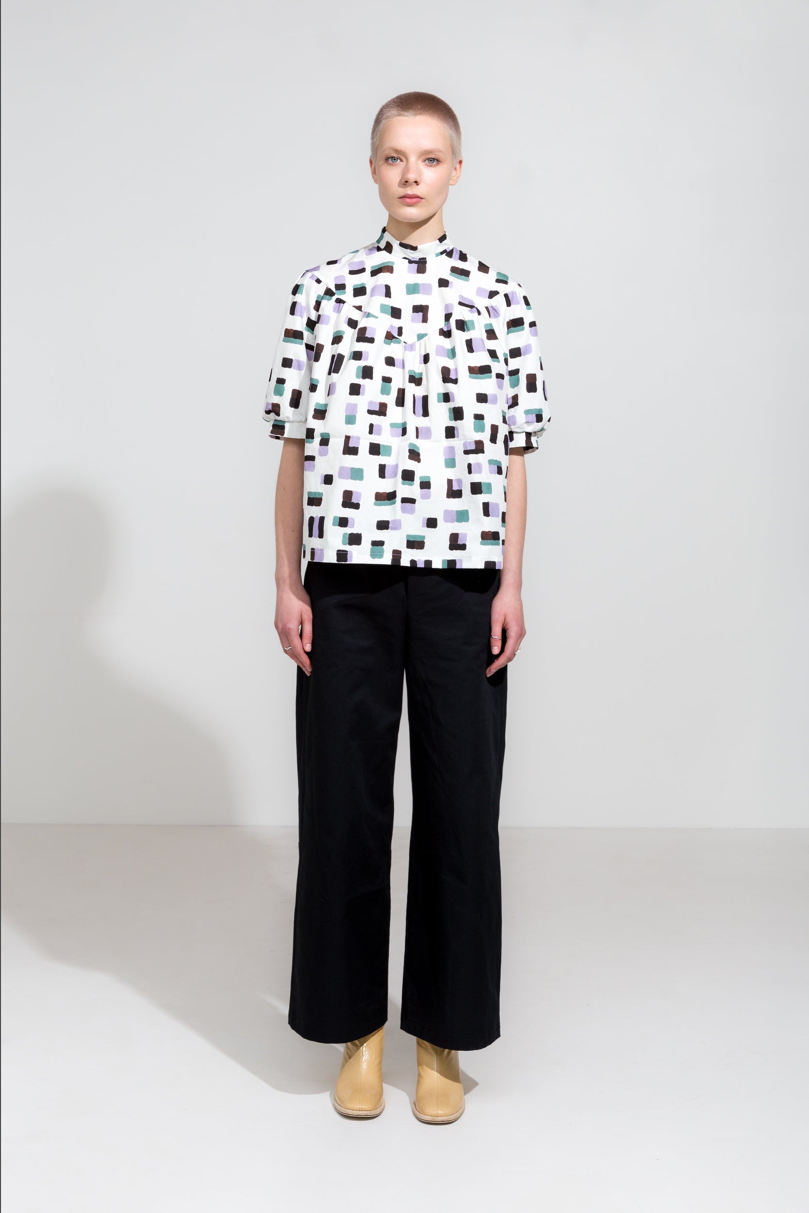 Puff sleeve shirt in print with high collar and black organic cotton workwear pants