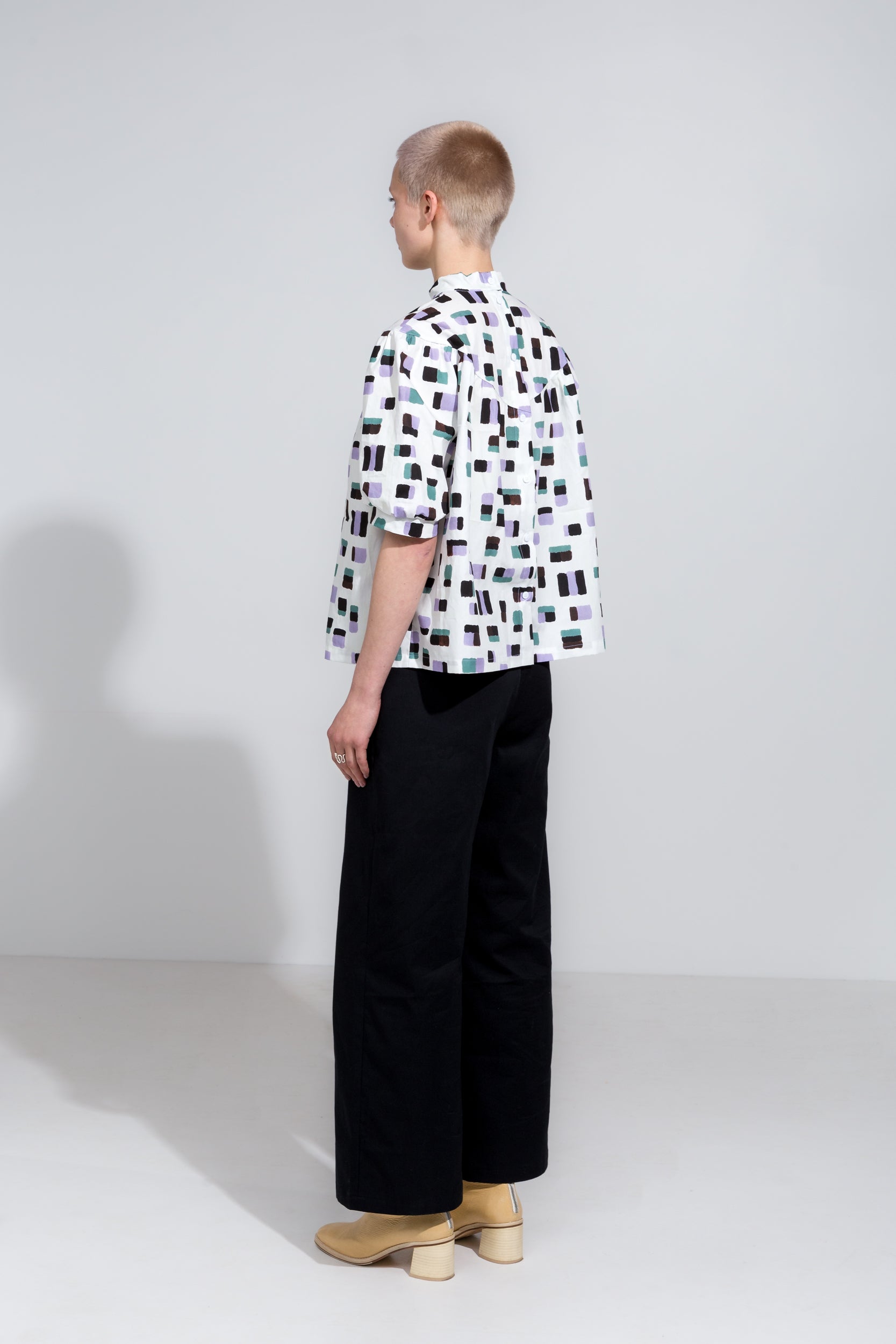 Puff sleeve shirt in print with high collar and black organic cotton workwear pants