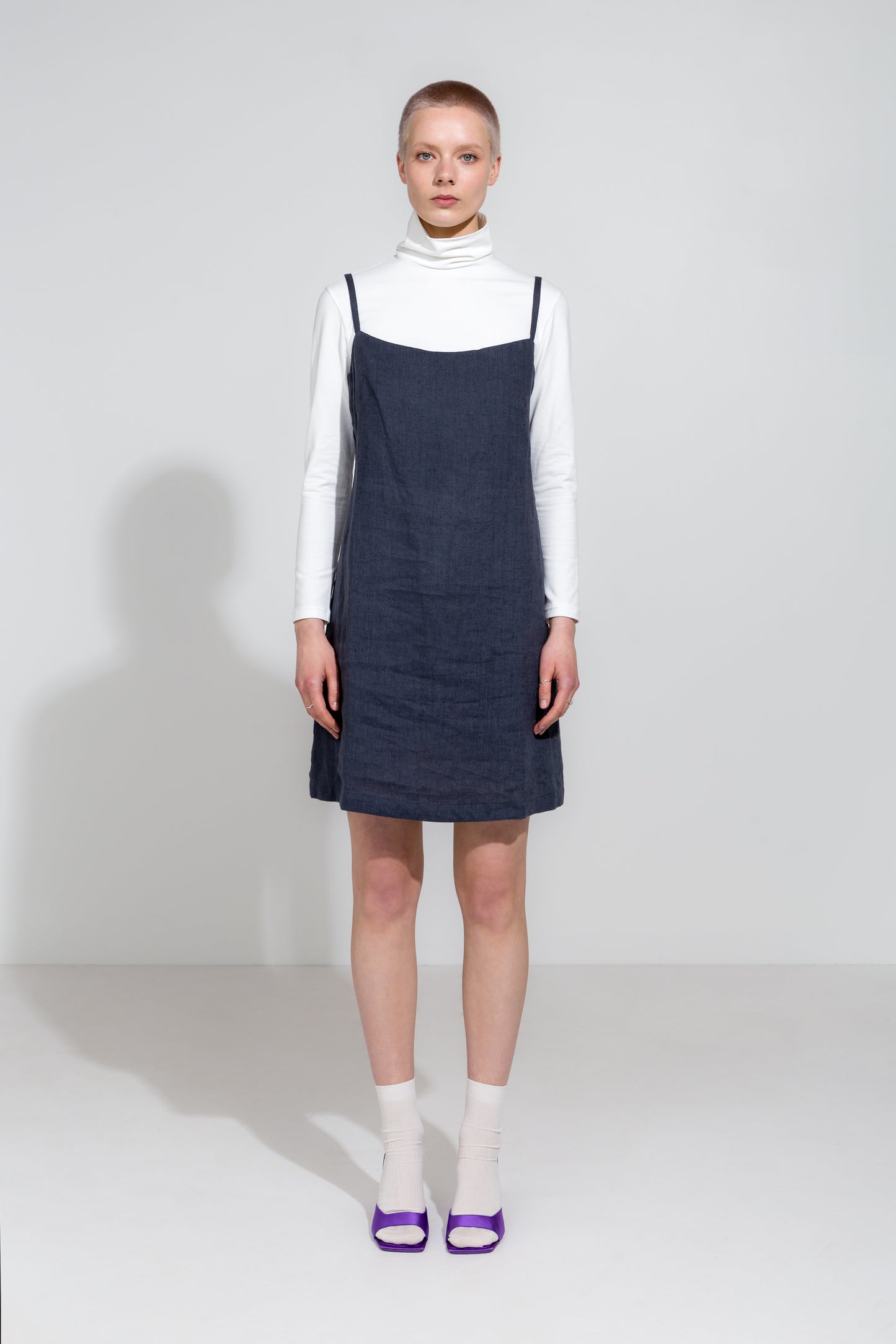 Dark grey linen strap dress and white organic roll neck