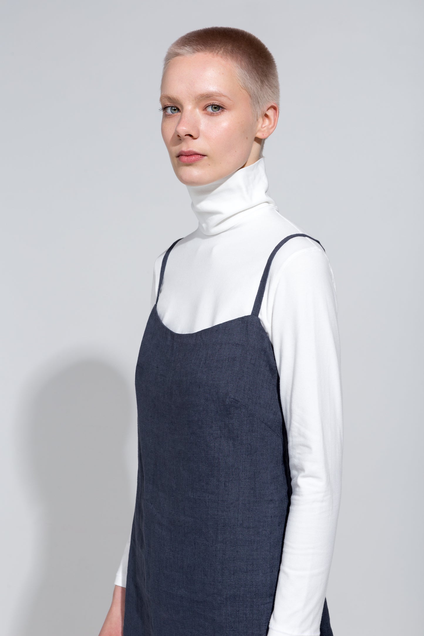 Dark grey linen strap dress and white organic roll neck